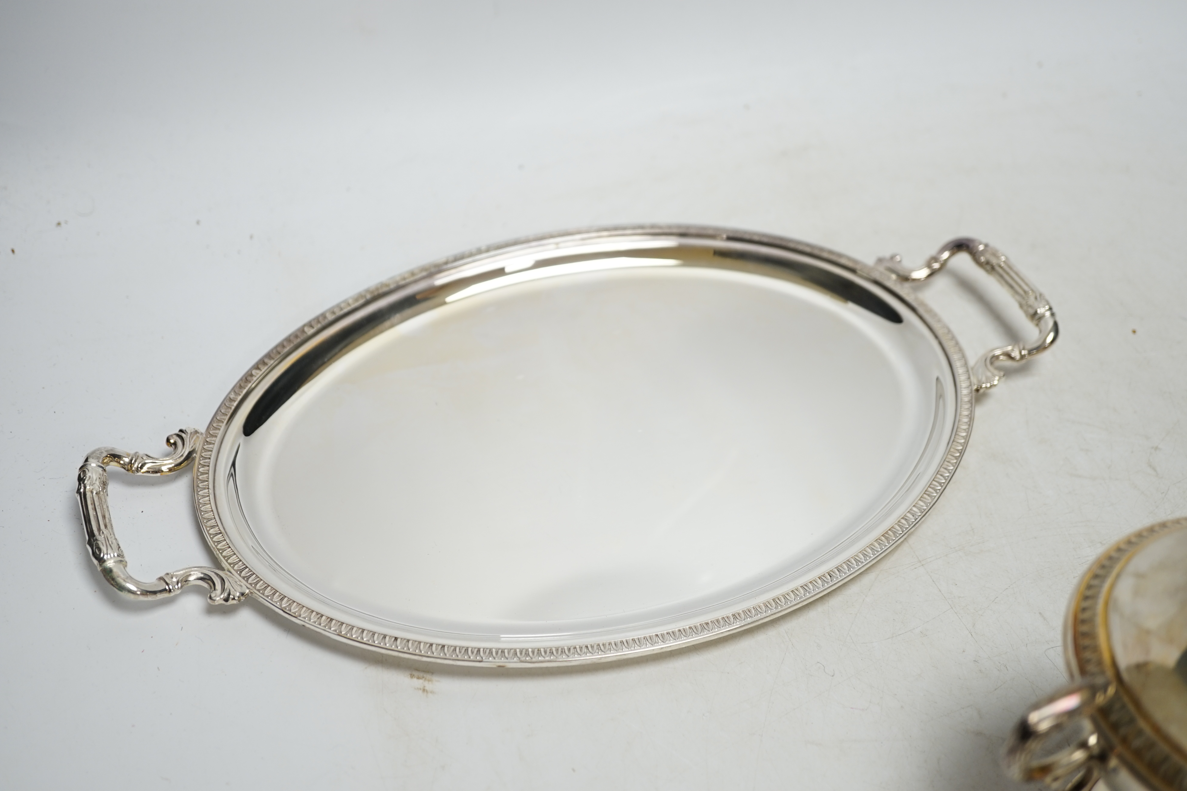 A modern Italian 800 standard two handled small oval tray, 33.6cm, a similar two handled cup and cover and a 925 shallow dish with matched 800 white metal cover, 33.7oz. Condition - fair to good